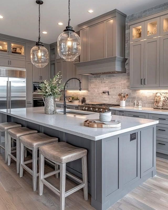 22. Elegant Warm Grey Kitchen Cabinets with Glass Pendant Lights - grey cabinet kitchen ideas
