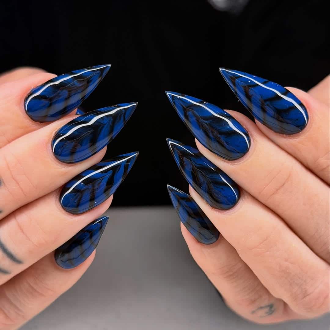 3. Midnight Blue and Black Marble Stiletto Nails - blue and black nail ideas