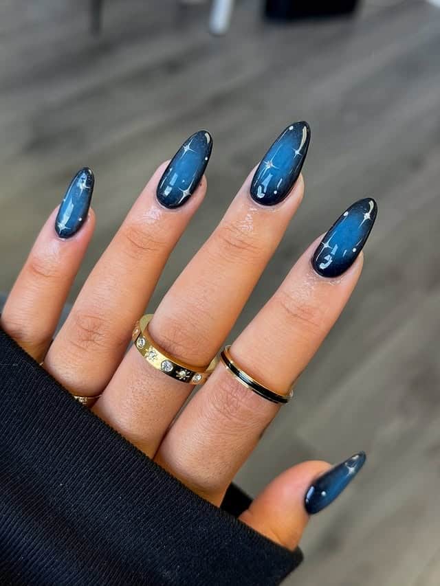 10. Navy Blue and Black Celestial Almond Nails - blue and black nail ideas