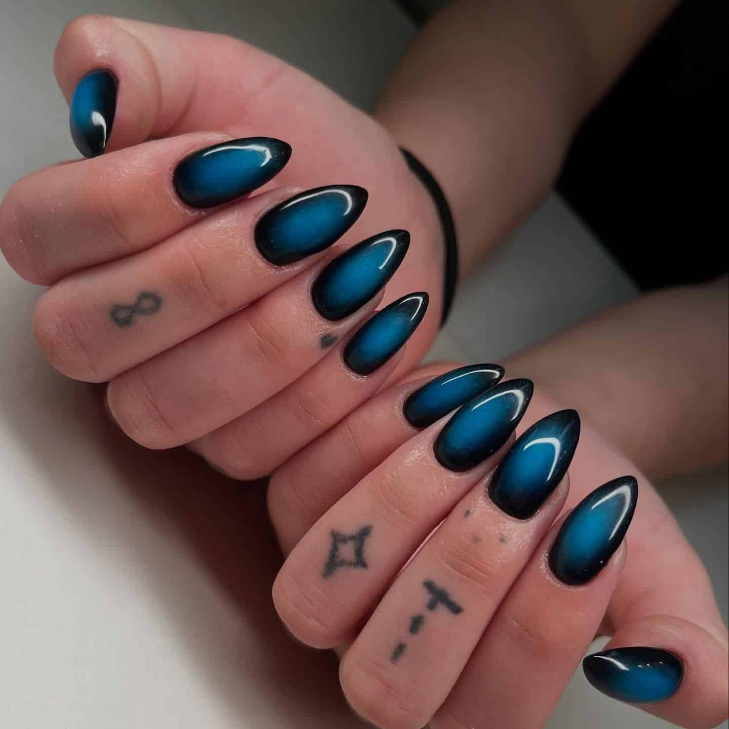 19. Deep Teal Blue and Black Ombre Almond Nails - blue and black nail ideas