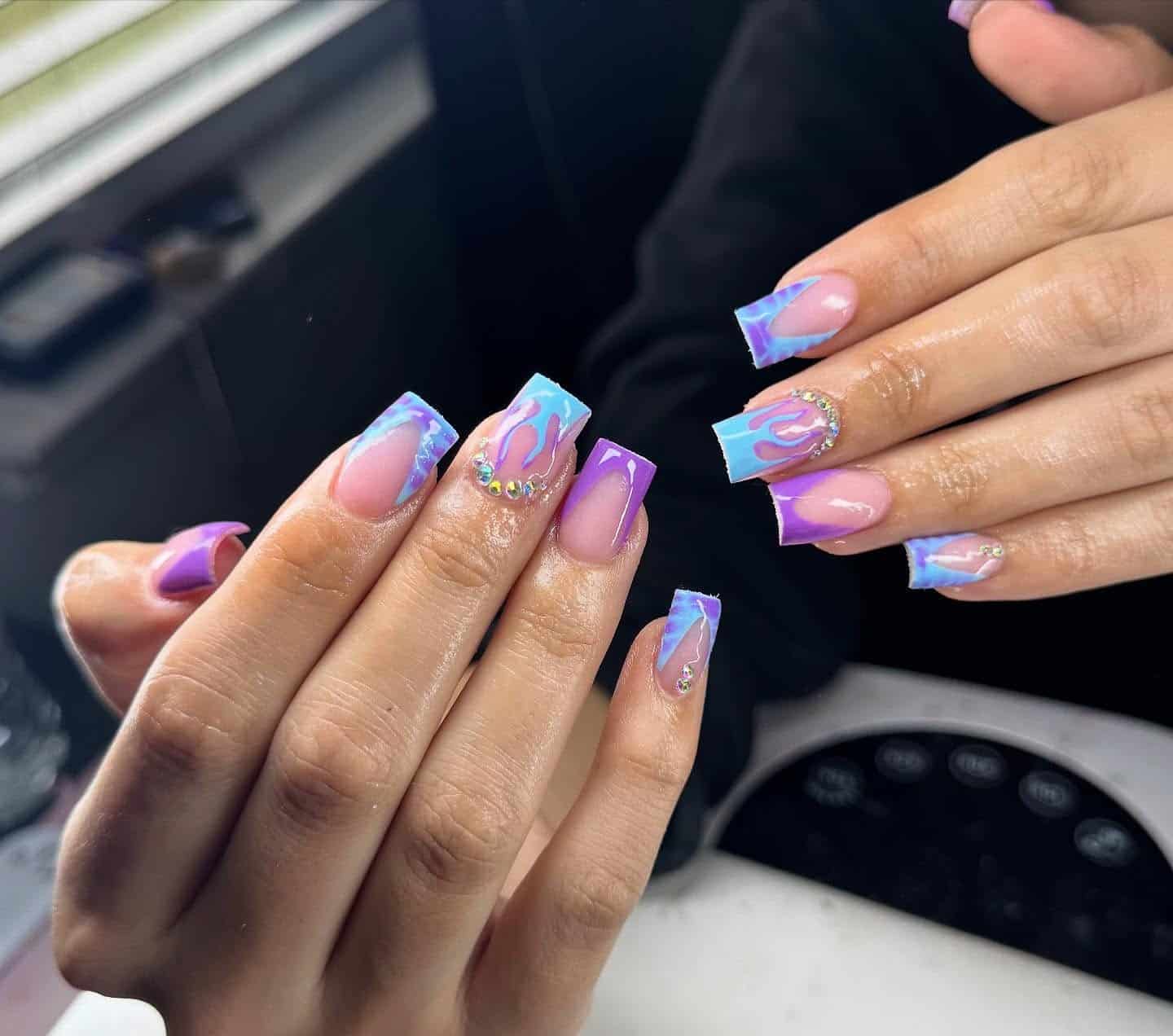 3. Blue and Purple Marble French Tip Nails with Rhinestones - blue and purple nail ideas