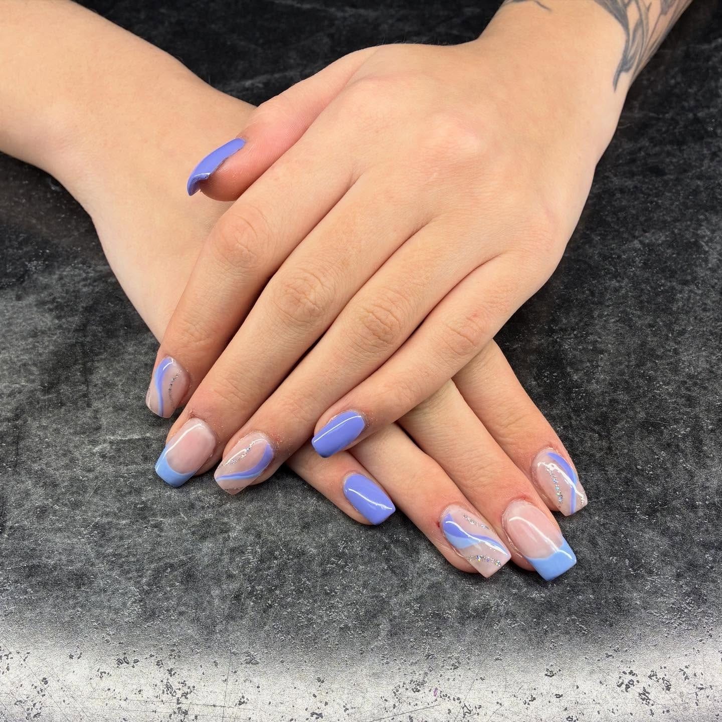 9. Periwinkle Blue and Silver Glitter Swirl Nails - blue and purple nail ideas