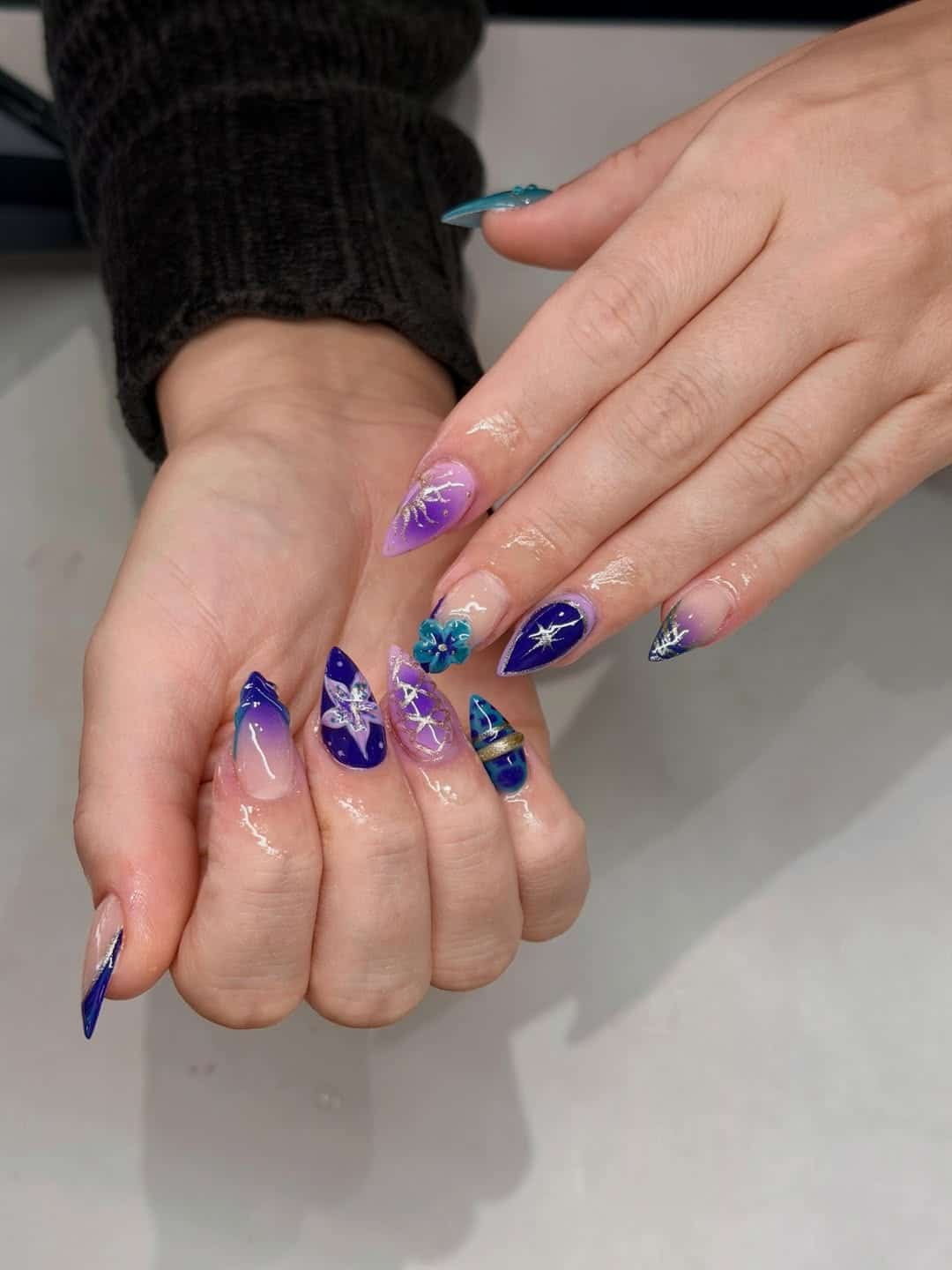 16. Royal Blue and Purple Celestial Stiletto Nails - blue and purple nail ideas