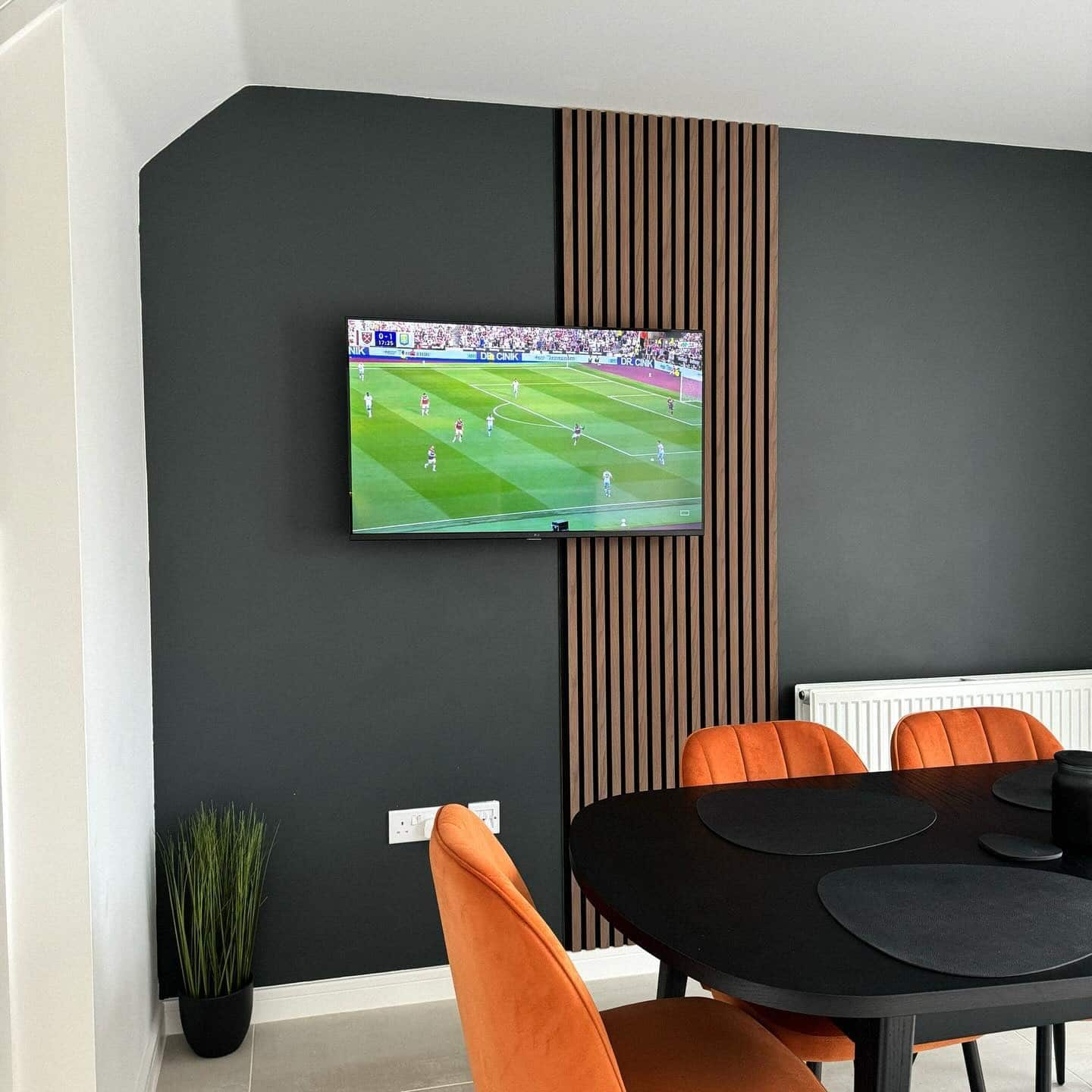 5. Charcoal Gray Kitchen Dining Feature Wall with Natural Wood Slat Detailing - feature wall kitchen ideas