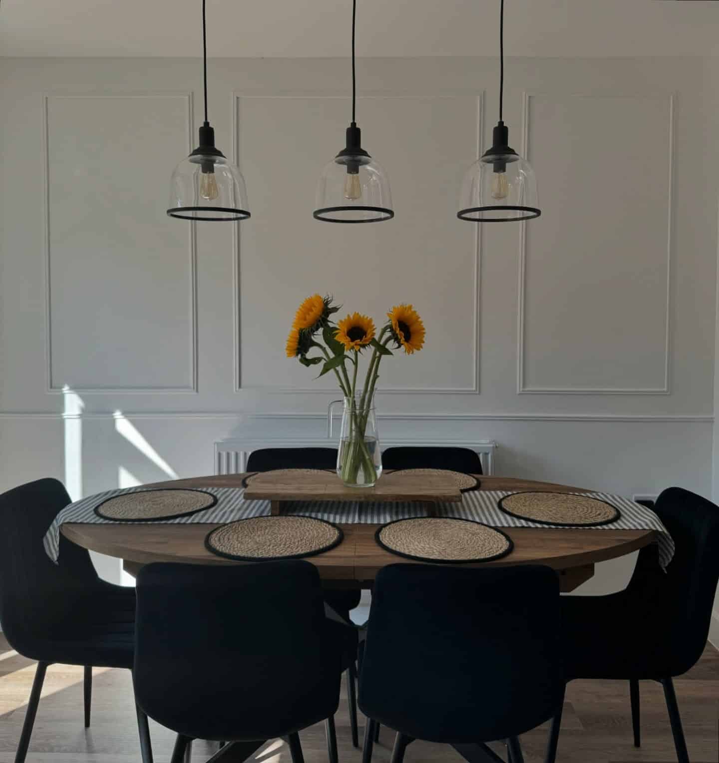 15. Classic White Paneled Kitchen Dining Feature Wall with Black Accents - feature wall kitchen ideas