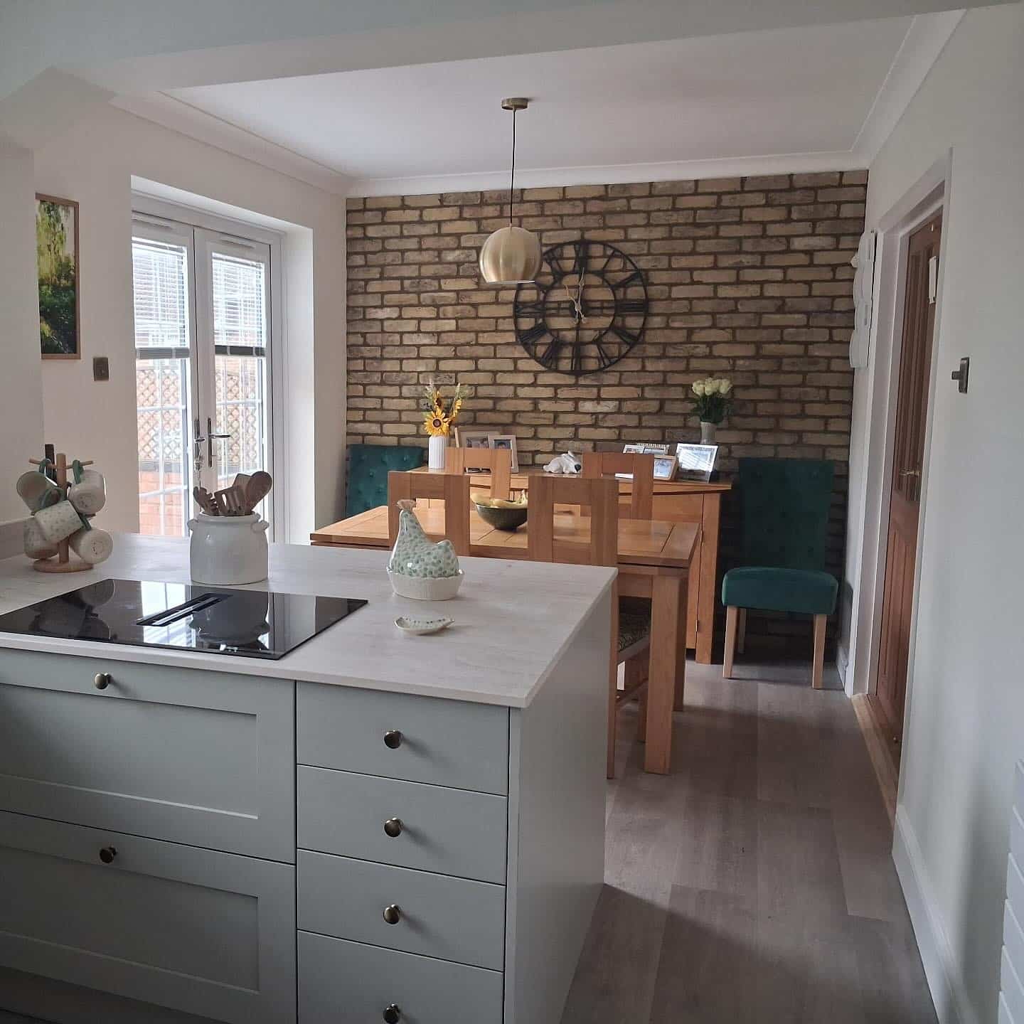 16. Rustic Brown Brick Kitchen Dining Feature Wall with Teal Green Seating - feature wall kitchen ideas