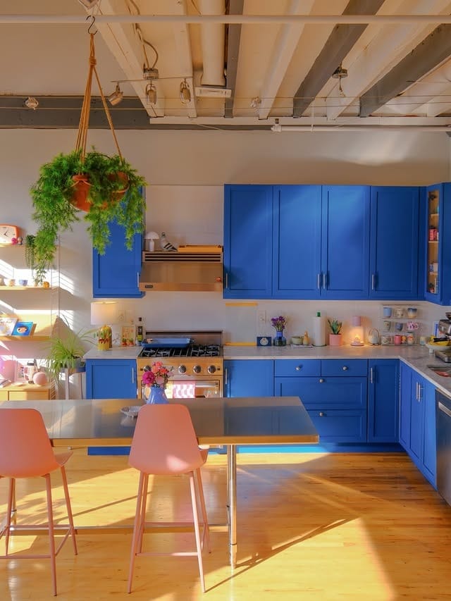 5. Electric Blue Kitchen with Pink Dining Chairs - bright kitchen ideas