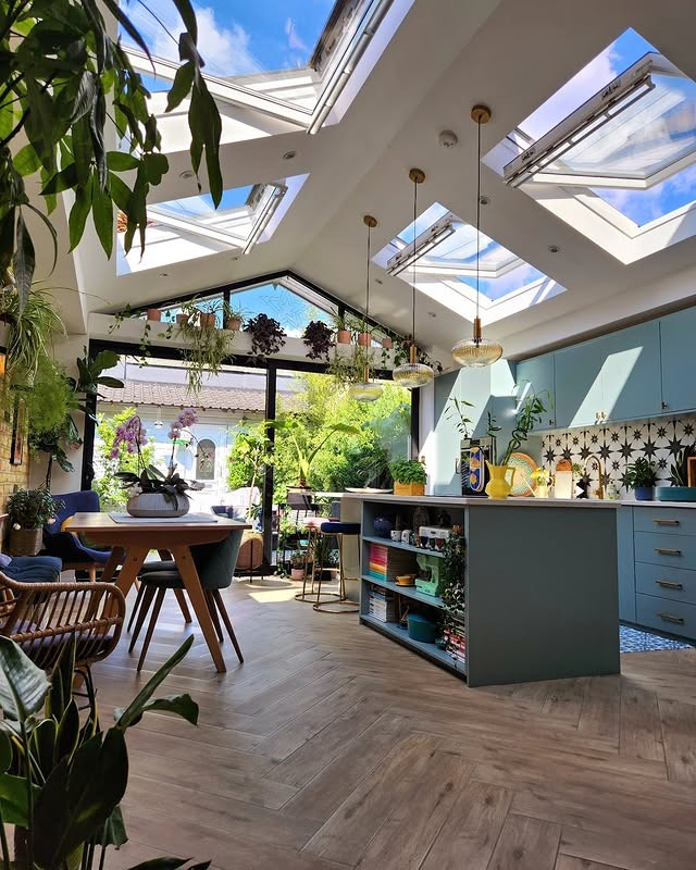15. Sky Blue Kitchen with Skylights and Garden Views - bright kitchen ideas