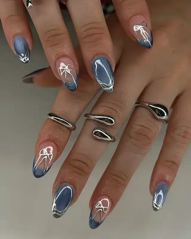 5. Denim Blue and Silver Bow Almond Nails - blue and silver nail ideas