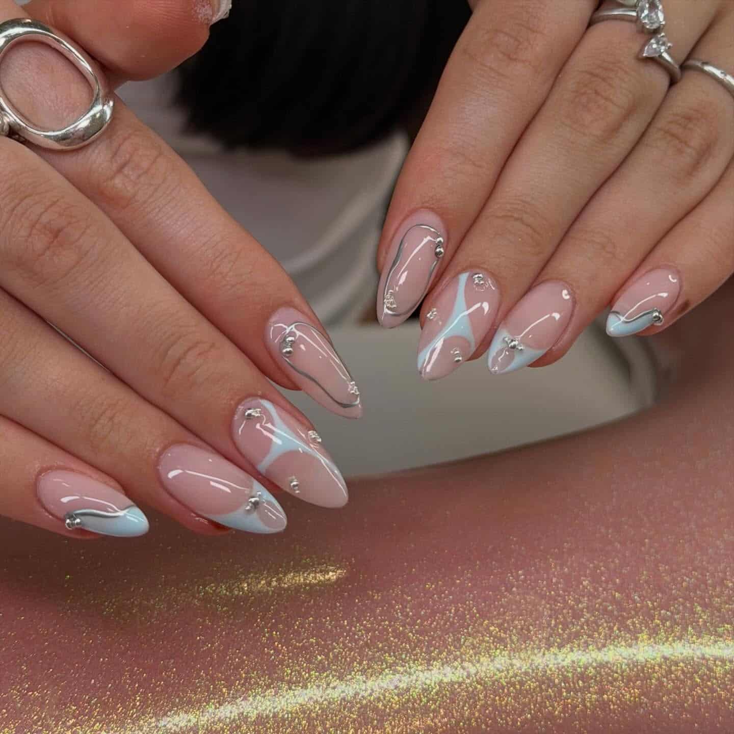 21. Baby Blue and Silver Chrome Swirl Almond Nails - blue and silver nail ideas
