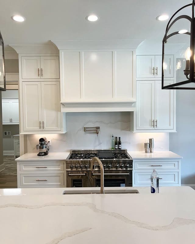4. Elegant White Kitchen with Marble Backsplash - all white kitchen ideas