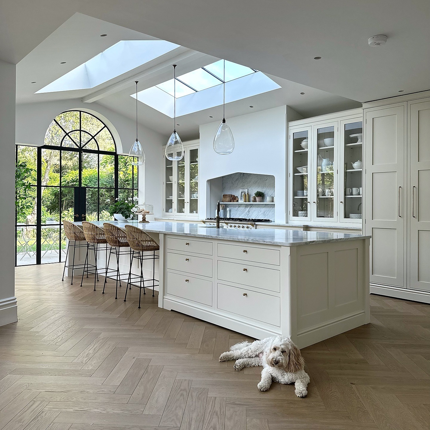 5. Luxury White Kitchen with Skylights and Glass Cabinets - all white kitchen ideas