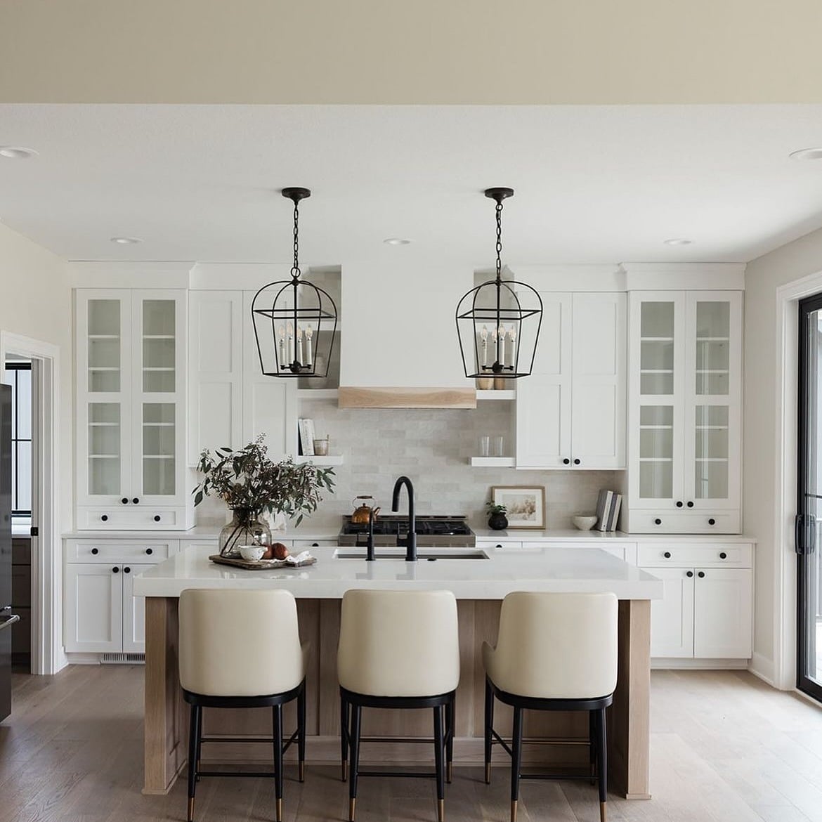 6. Modern Farmhouse White Kitchen with Black Lantern Lights - all white kitchen ideas