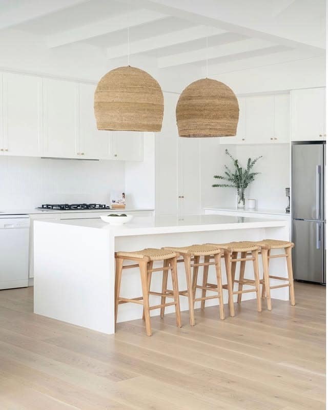 16. Coastal All White Kitchen with Natural Rattan Accents - all white kitchen ideas