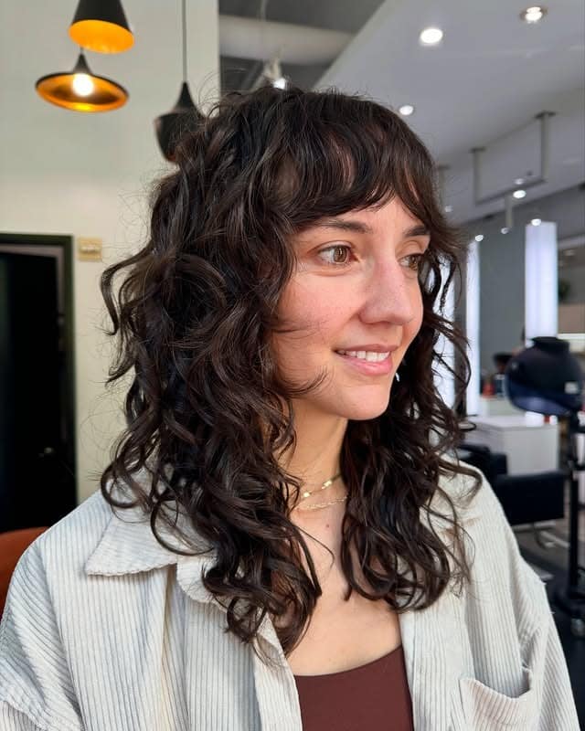 6. Dark Chocolate Curly Shag with Piecey Bangs - Shaggy Haircut