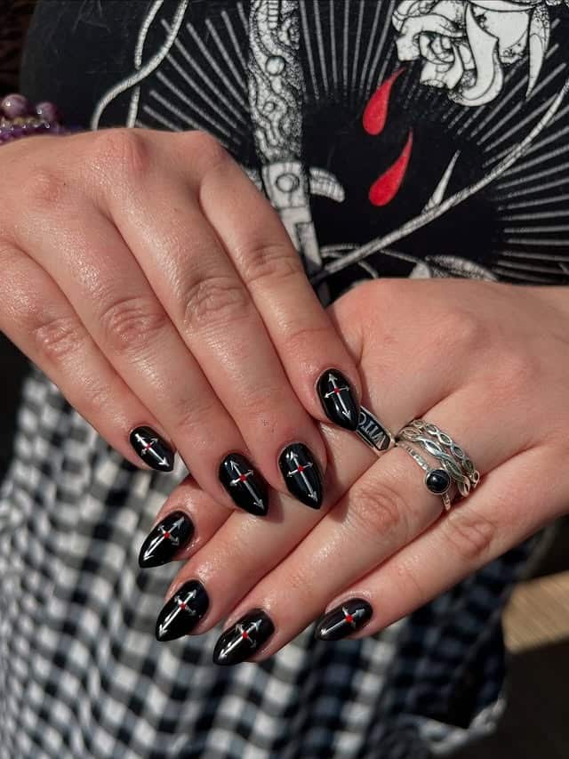 3. Glossy Black Almond Nails with Minimalist Cross Art - cross nail ideas