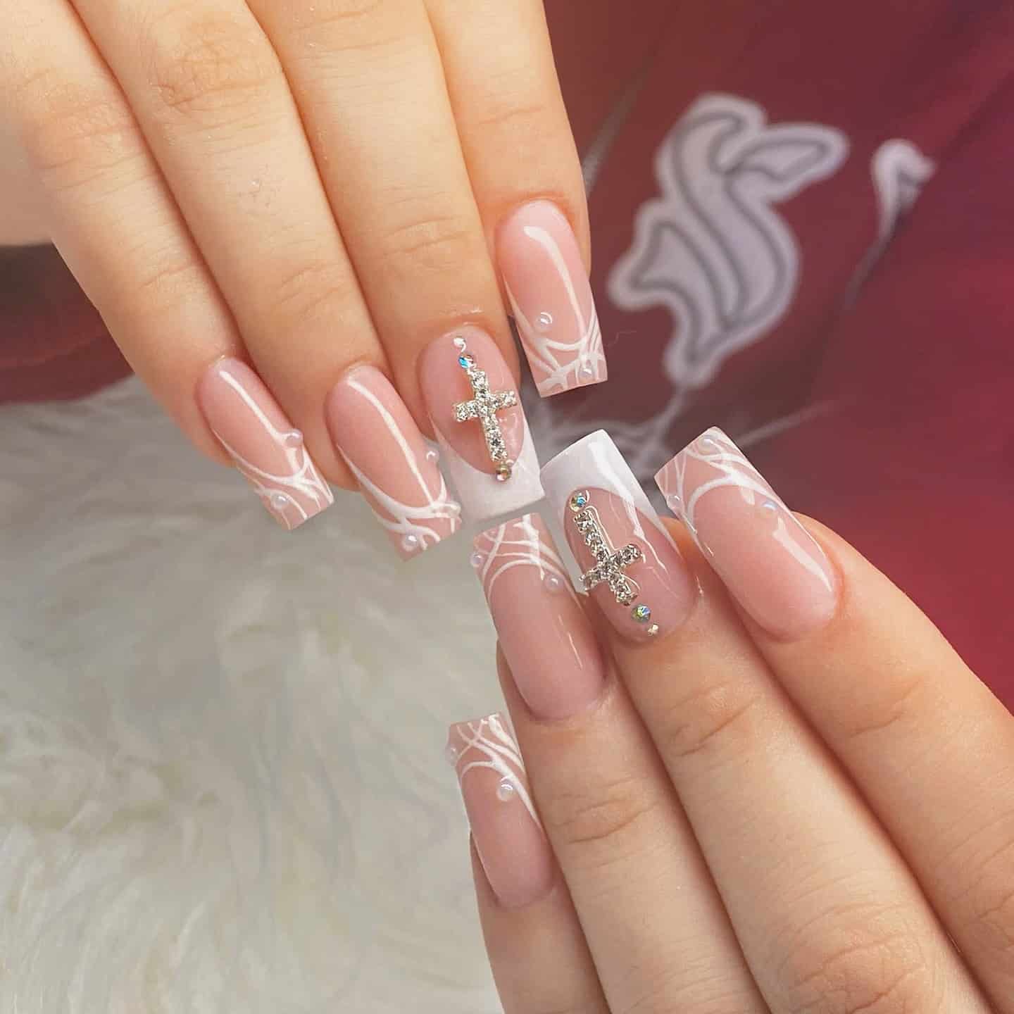 6. Soft Pink and White Cross Nails with Silver Charms - cross nail ideas