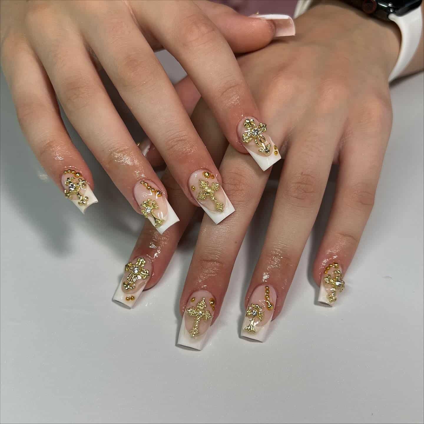 9. White French Tip Nails with Gold Cross Charms - cross nail ideas