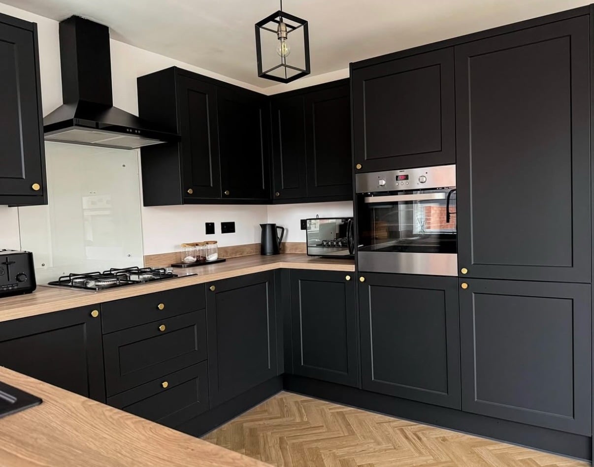 4. Classic Black Shaker Kitchen with Warm Wood Countertops - black kitchen decor ideas