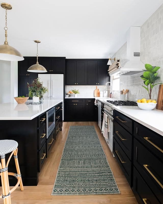 5. Elegant Black and White Kitchen with Brass Hardware - black kitchen decor ideas