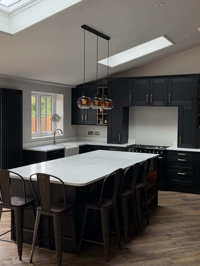 10. Modern Black Kitchen with White Quartz Island and Skylights - black kitchen decor ideas