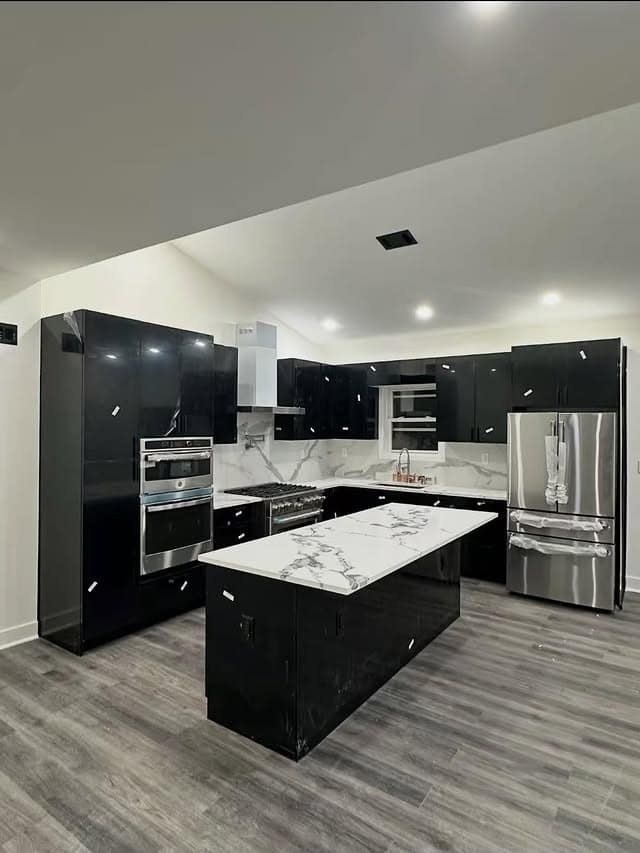 11. Modern Glossy Black Kitchen with White Marble Countertops - black kitchen decor ideas