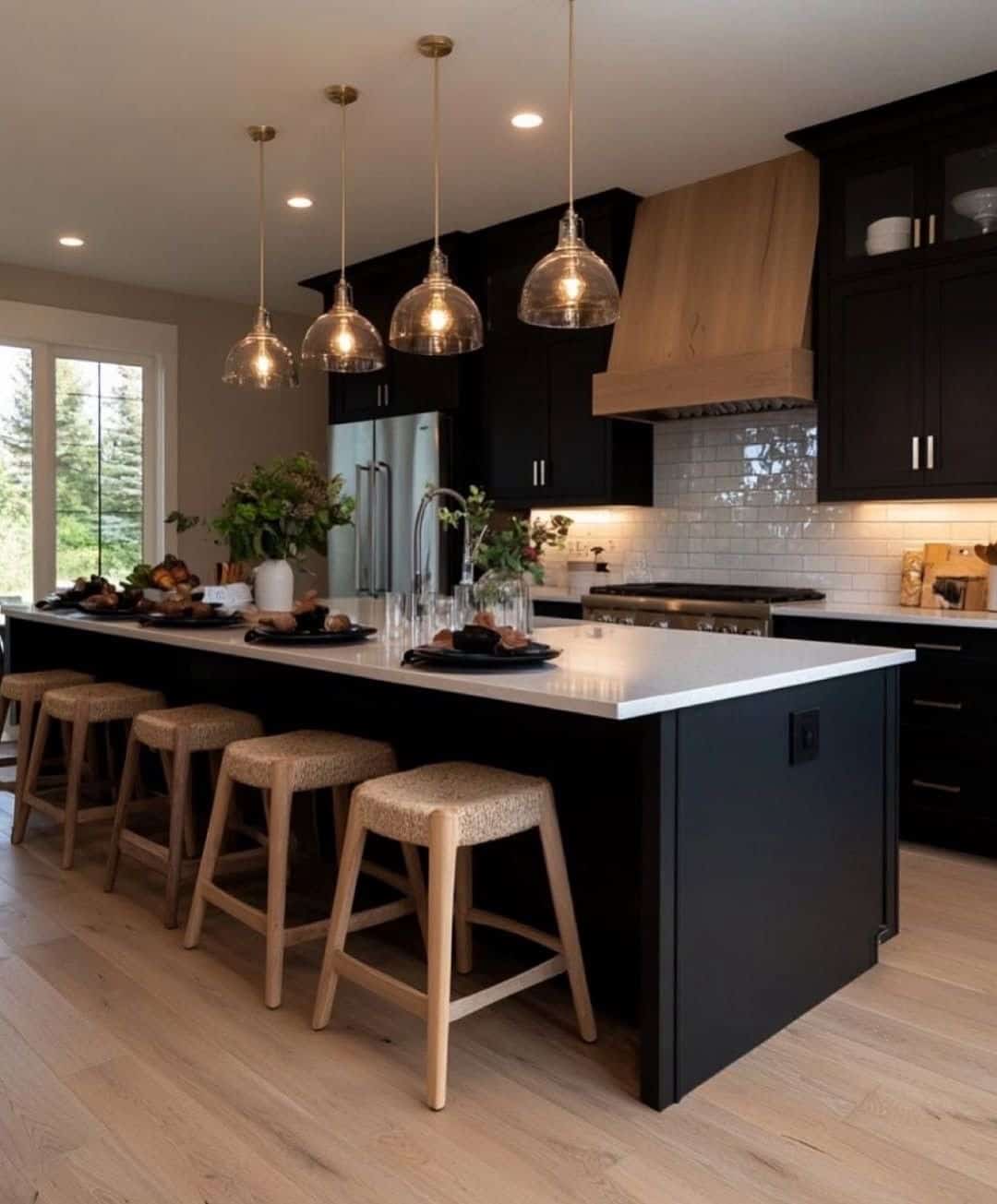 18. Modern Farmhouse Black Kitchen with Natural Wood Range Hood - black kitchen decor ideas