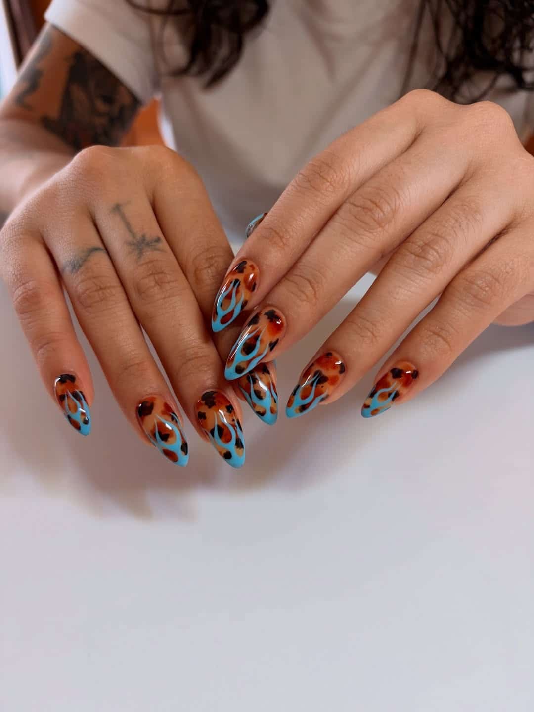 4. Tortoiseshell and Blue Flame Almond Nails - flame nail ideas
