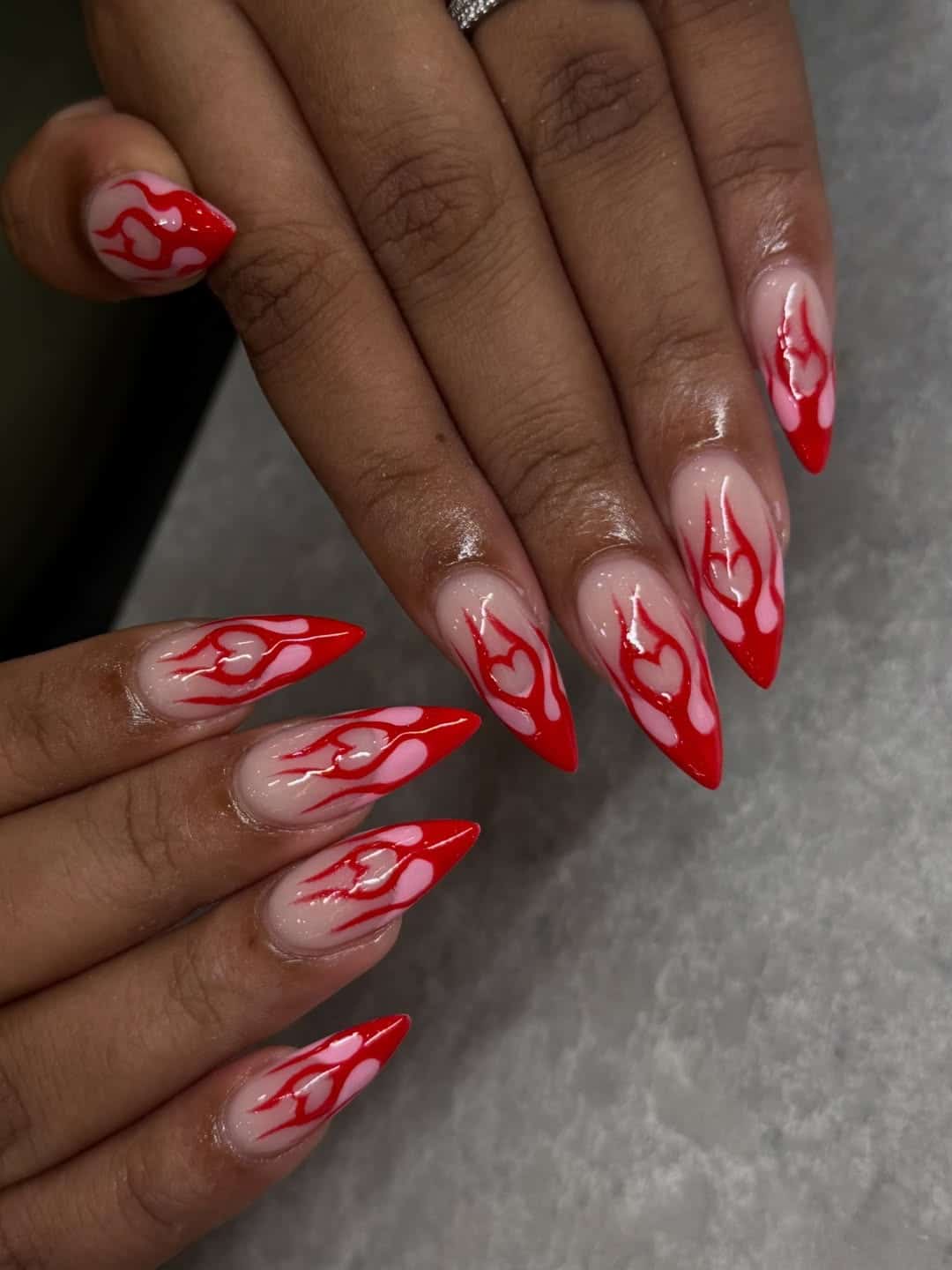 9. Red Flame Stiletto Nails with Pink Hearts - flame nail ideas