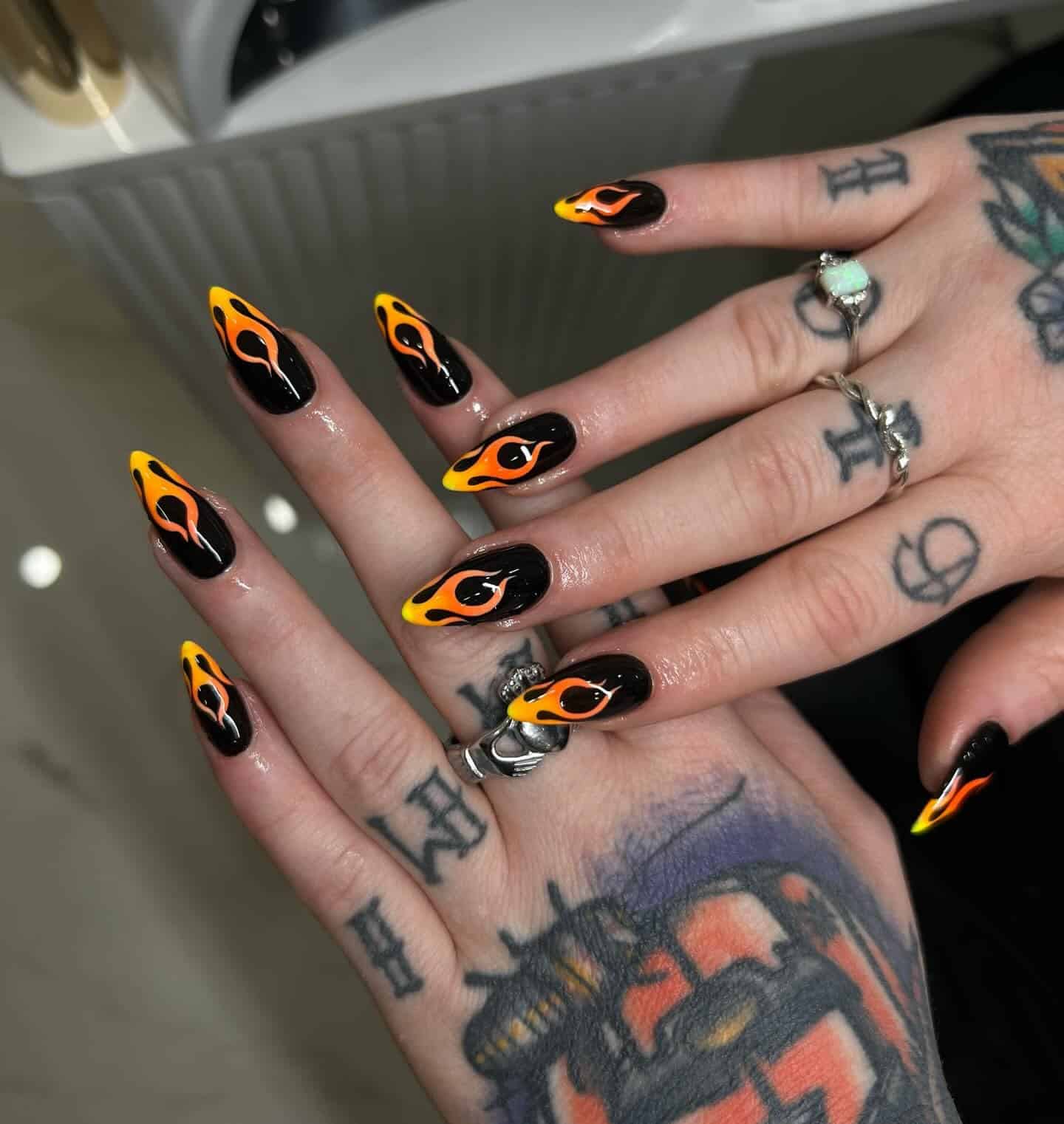 22. Black and Orange Flame Stiletto Nails - flame nail ideas