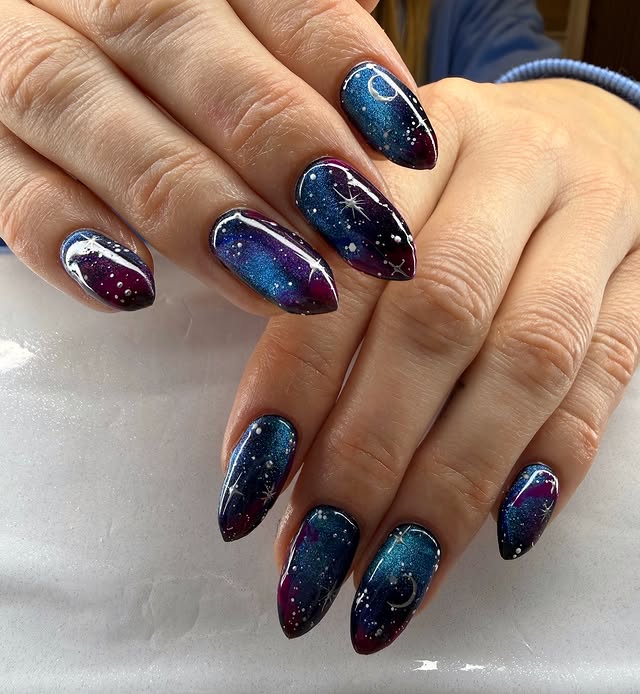 2. Midnight Blue and Purple Starry Galaxy Almond Nails - galaxy nail ideas