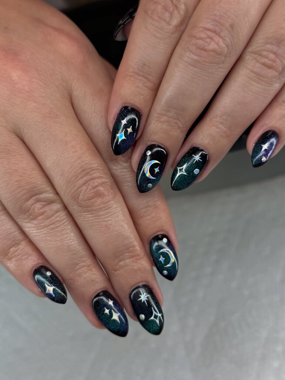 13. Black and Holographic Silver Moon Galaxy Almond Nails - galaxy nail ideas