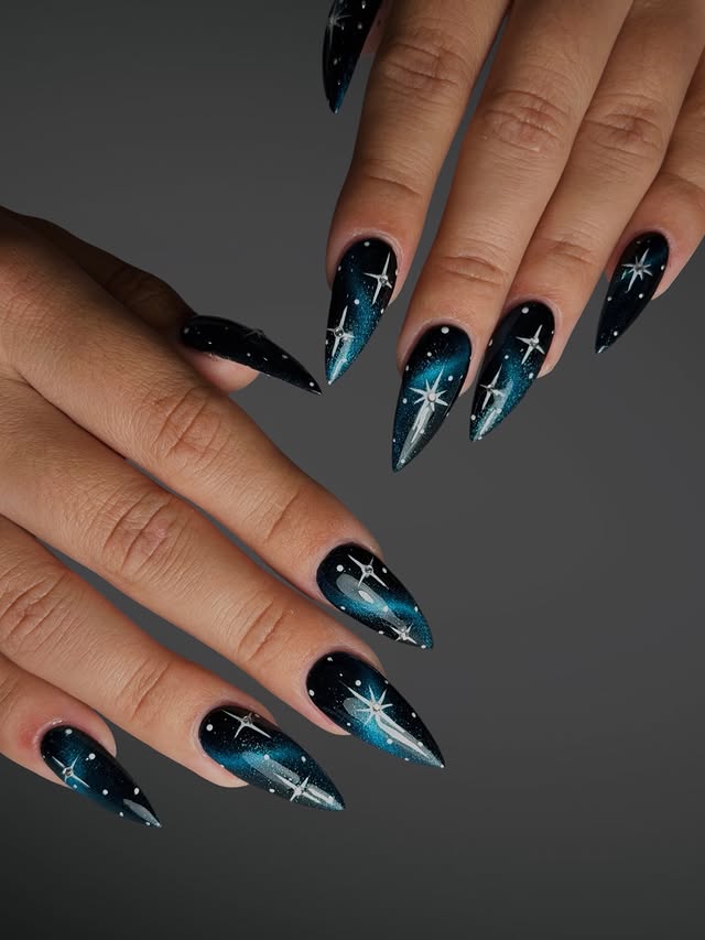 15. Black and Teal Starry Galaxy Stiletto Nails - galaxy nail ideas