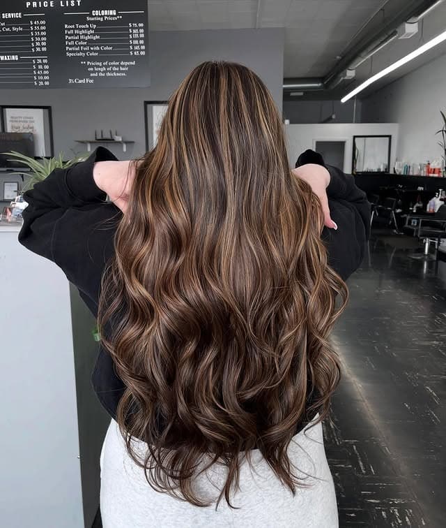 4. Caramel Brown Highlights on Long Chocolate Waves - Hair Color with Highlights