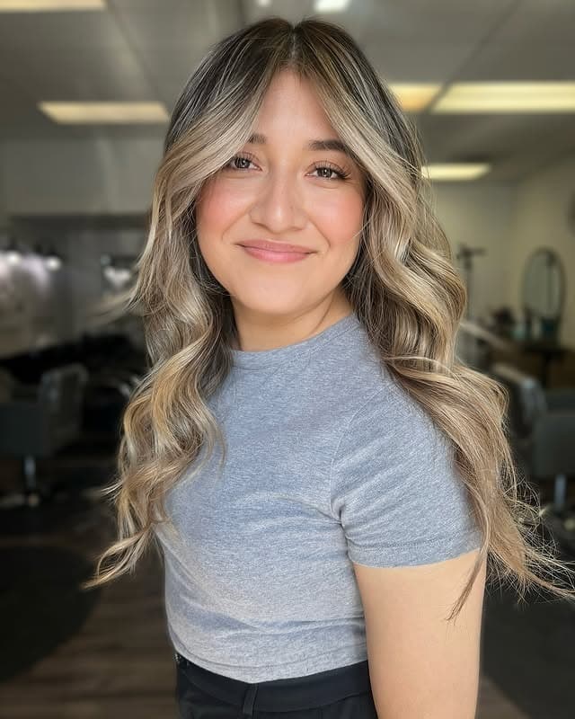 8. Sandy Blonde Highlights on Long Loose Waves - Hair Color with Highlights
