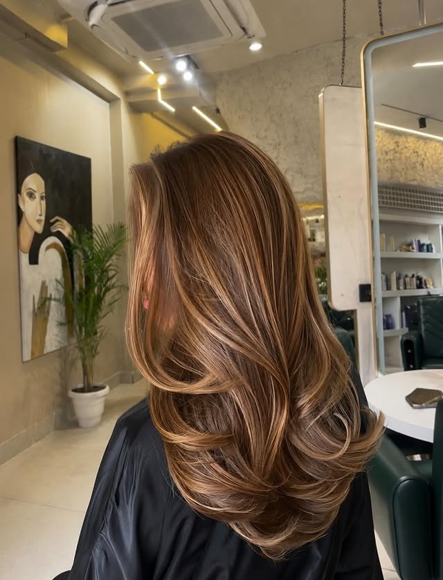 22. Golden Caramel Highlights on a Medium-Length Layered Blowout - Hair Color with Highlights