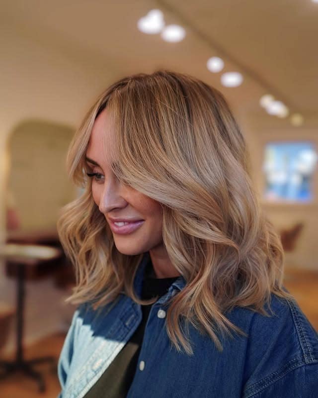 7. Honey Blonde Shoulder-Length Waves with Curtain Bangs - Chic-Length Hairstyles