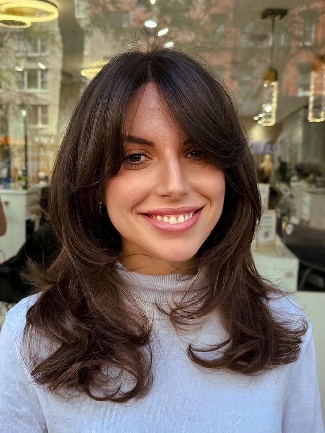 11. Rich Chocolate Brown Butterfly Cut with Wispy Curtain Bangs - Chic-Length Hairstyles
