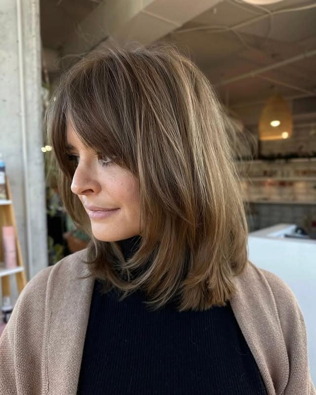 13. Mushroom Brown Shoulder-Length Lob with Side-Swept Layers - Chic-Length Hairstyles