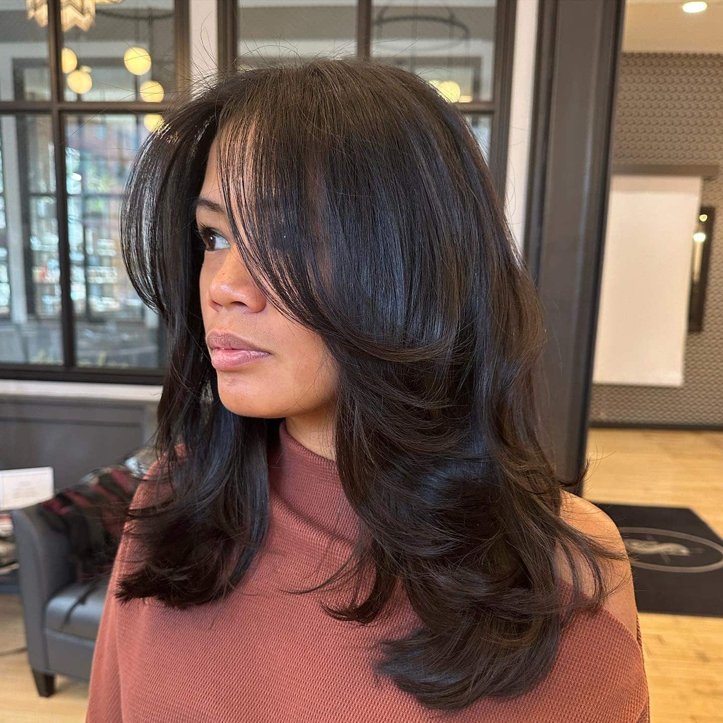 20. Glossy Dark Brunette Butterfly Cut with Dramatic Face-Framing Layers - Chic-Length Hairstyles