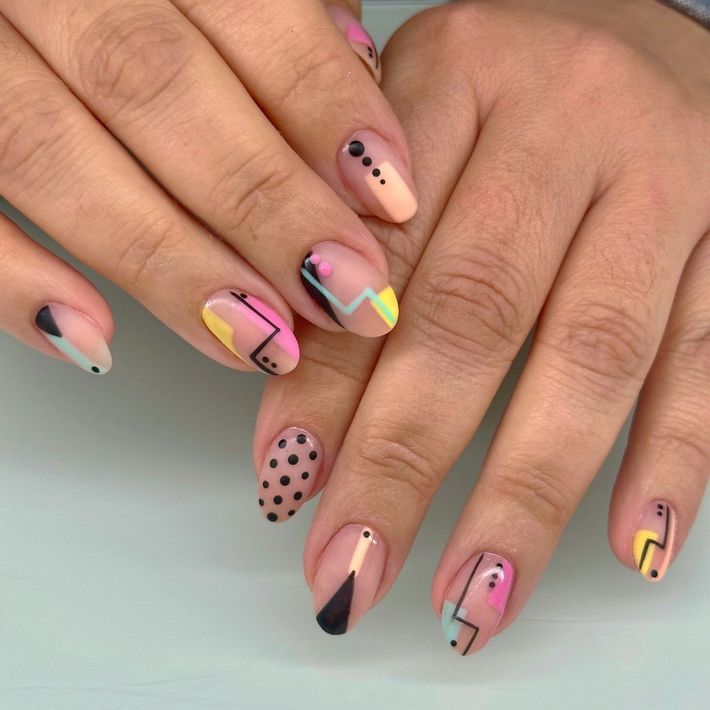 4. Pastel Pink and Yellow Abstract Geometric Nails - geometric nail ideas