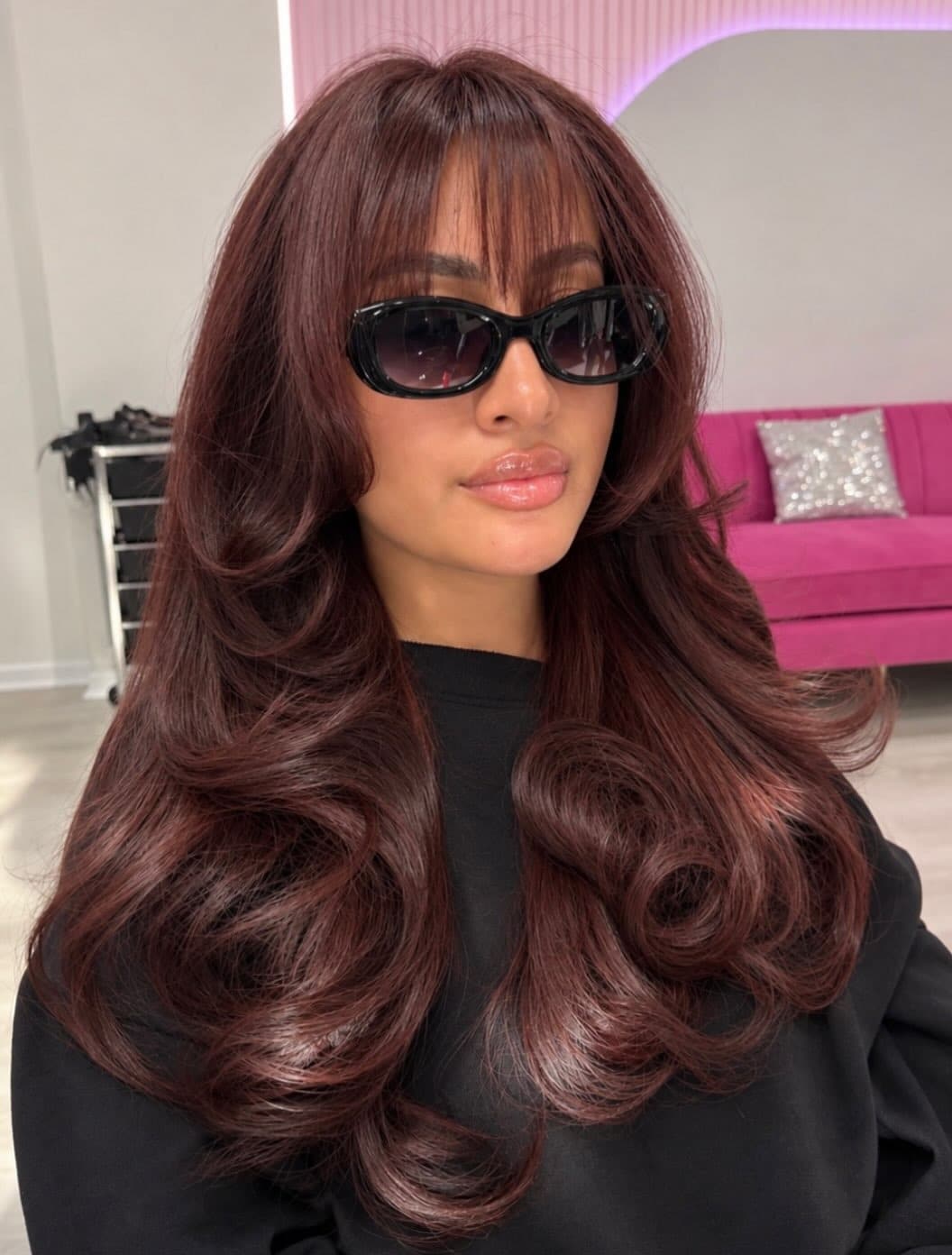 3. Smoky Dark Auburn Hair with Wispy Bangs and Feathered Layers - Dark Auburn Hair Color