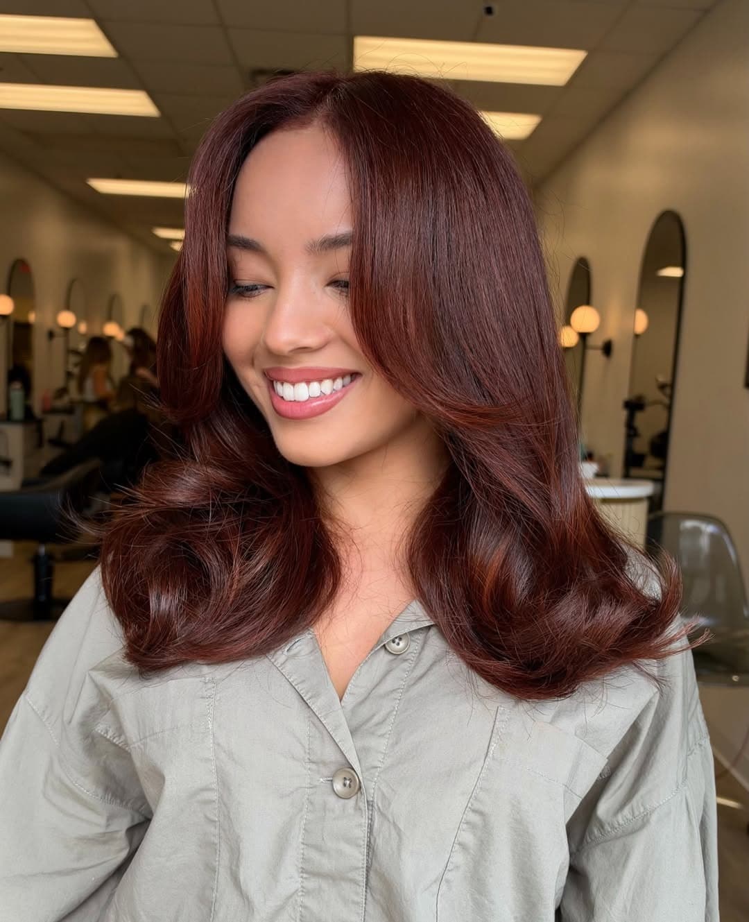 9. Vibrant Dark Auburn Hair with Bouncy Face-Framing Layers - Dark Auburn Hair Color