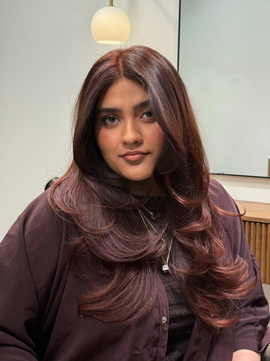 10. Rich Rosewood Auburn Hair with Voluminous Butterfly Layers - Dark Auburn Hair Color