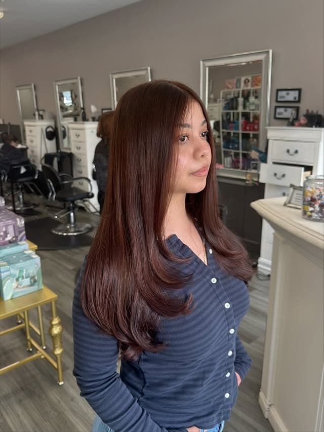 17. Glossy Dark Mahogany Auburn Hair with Sleek Long Layers - Dark Auburn Hair Color