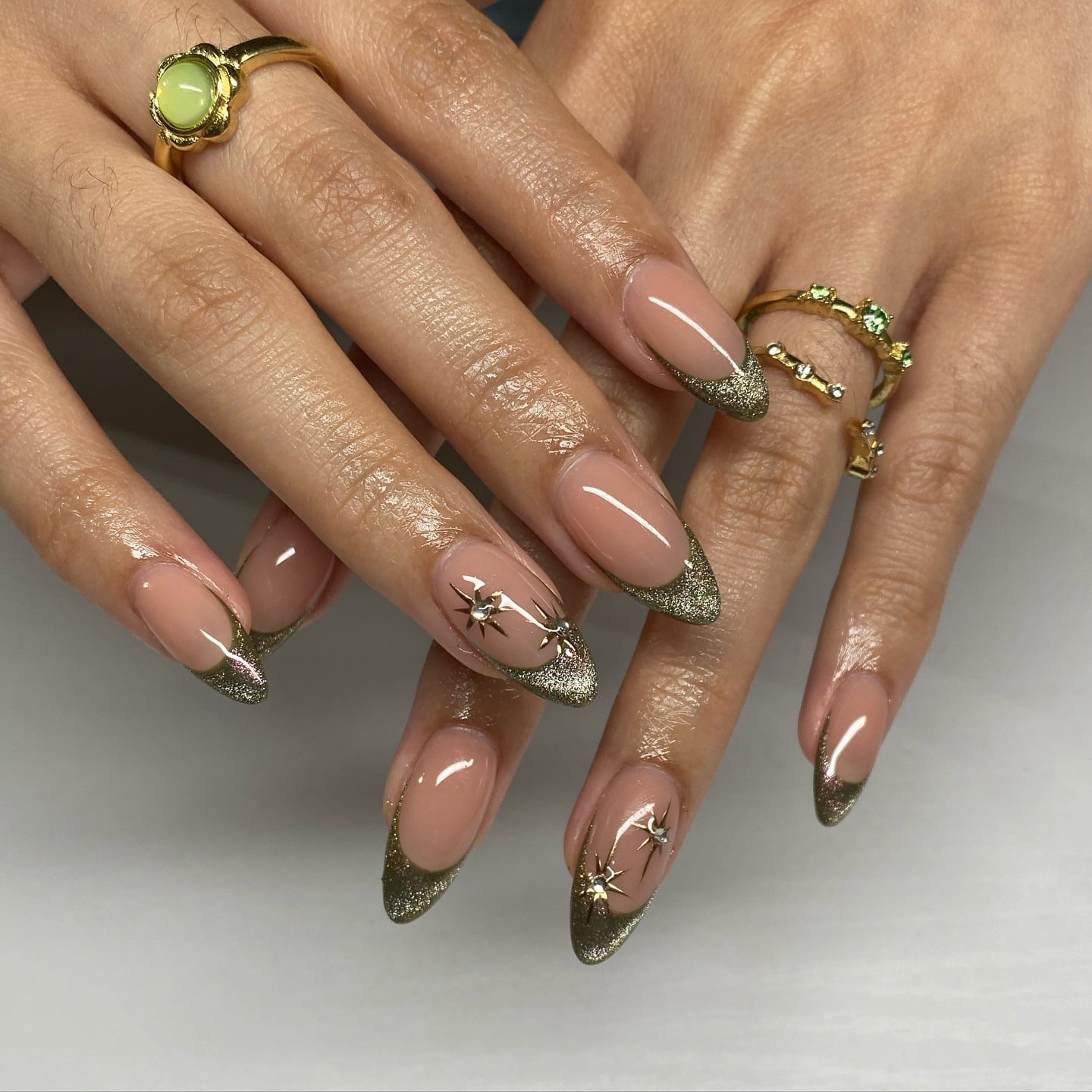 1. Glittery Olive Green French Tip Nails with Gold Stars - green and gold nail ideas