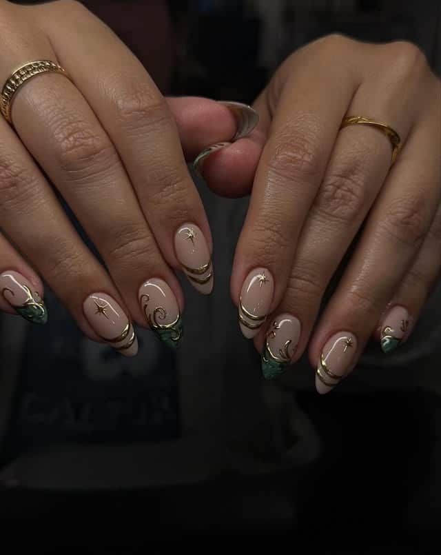 8. Forest Green French Tip Nails with Gold Celestial Swirls - green and gold nail ideas