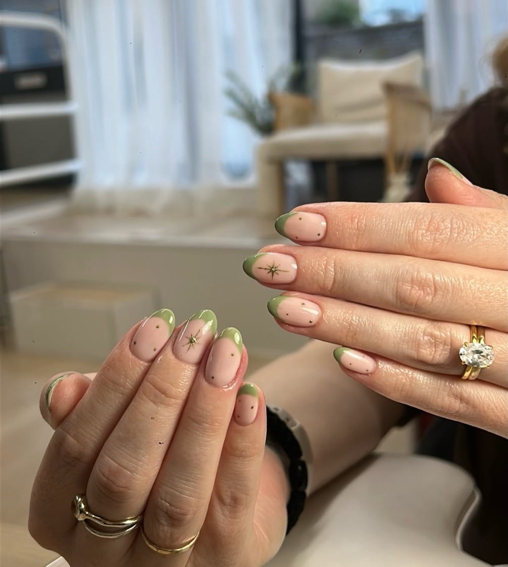 10. Light Sage Green French Tip Nails with Gold Star Accents - green and gold nail ideas
