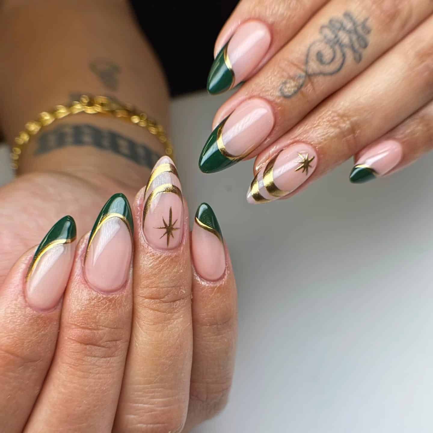 15. Forest Green French Tip Nails with Gold Celestial Accents - green and gold nail ideas
