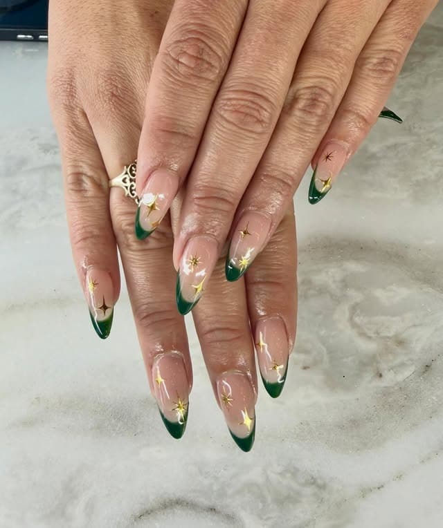 18. Forest Green French Tip Nails with Gold Starbursts - green and gold nail ideas